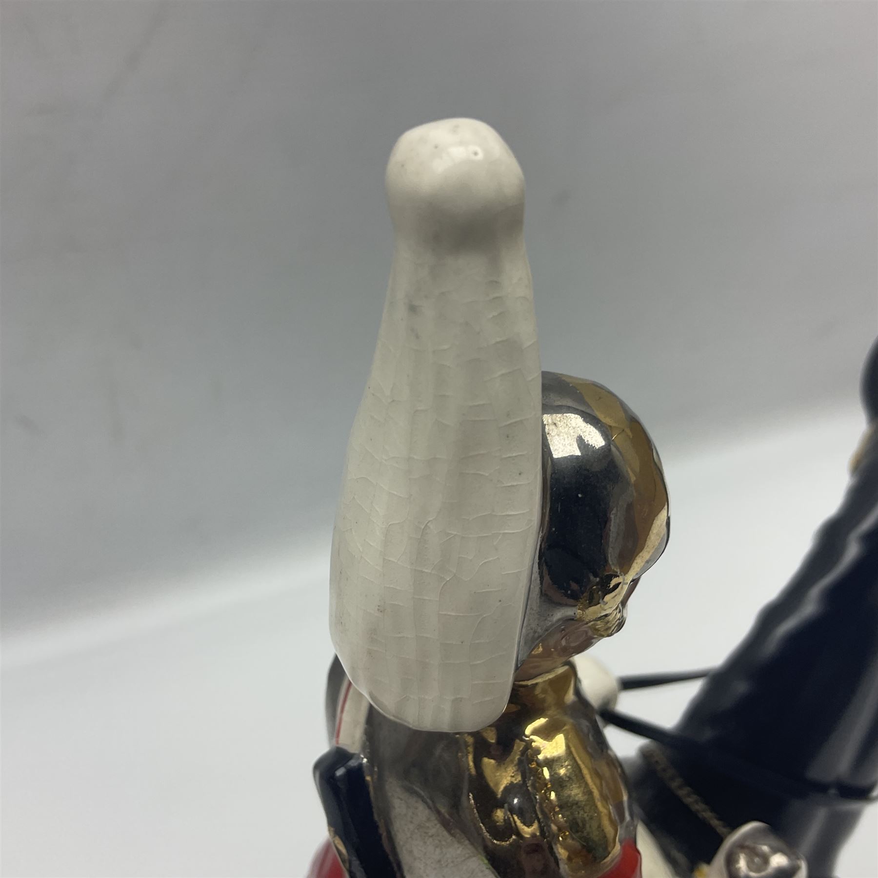 Mounted Lifeguard upon a black horse, in the style of Beswick, upon a wooden plinth, H31cm