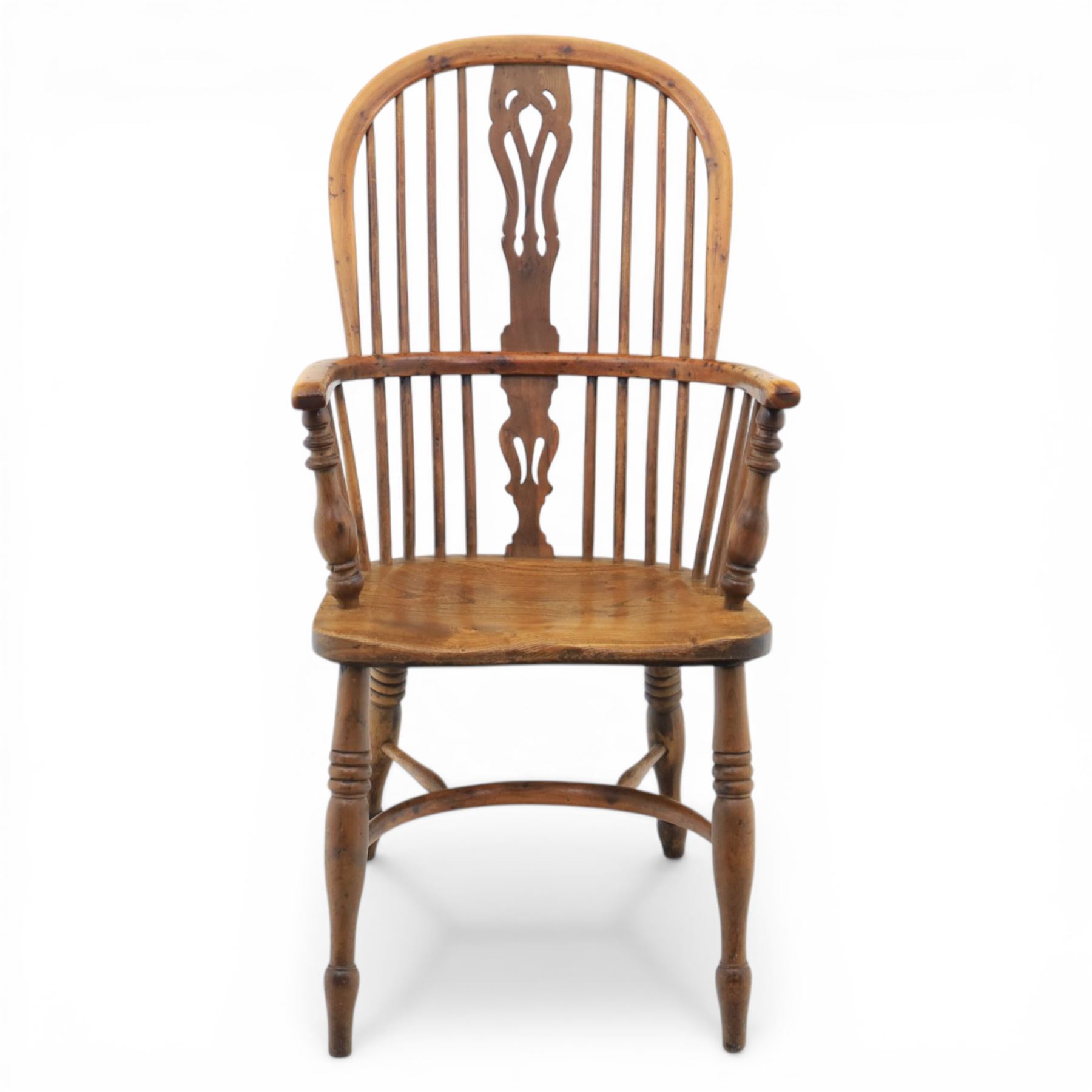 Early 20th century yew wood Windsor armchair, hooped back with spindle supports and shaped pierced central splat, solid seat with shaped edge, turned arm supports, on turned legs united by crinoline stretcher