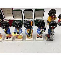 Eight ceramic Golly Band figurines marked Carlton Ware, together with four other Golly figures and five boxed badges