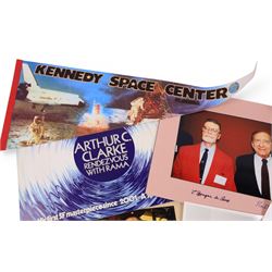 Collection of ephemera relating to Arthur C Clarke, including colour photograph of Arthur with author Joe Green, Jay Kubica and astronaut Chris Hadfield at NASA Kennedy Space Centre, Kennedy Space Centre pennant flag, colour photographs of authors Sam Moskowitz with Forrest Ackerman and L. Sprague de Camp with Robert Bloch, all signed below by the authors, a black and white photograph of Arthur for his 13-Part ITV series 'Arthur C Clarke's Mysterious World', Pan Books cardboard advertisement for Rendezvous with Rama and an Evening Standard poster for The Other Side of the Sky

Notes: This item is from the private collection of Arthur C. Clarke's brother.