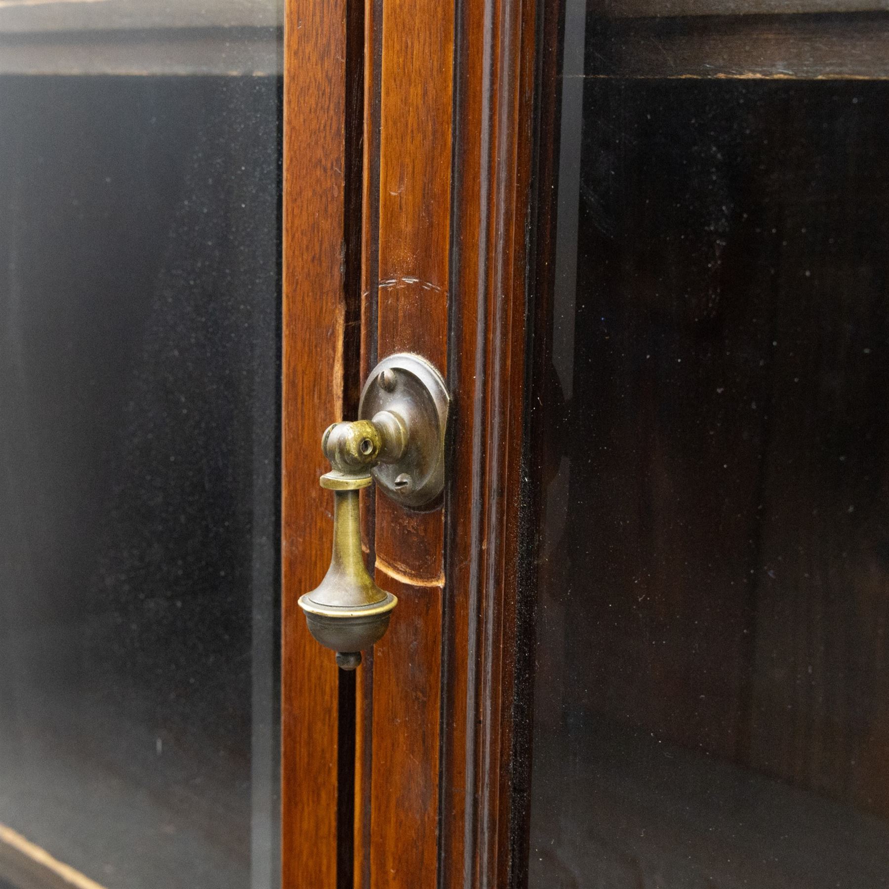 Late 19th century walnut library bookcase, fitted with four display doors with astragal bevelled panes, raised upon a four cupboard base with fielded panel doors