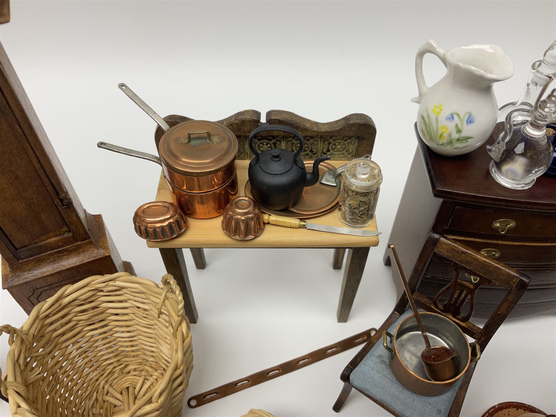 Collection of miniature dolls house furniture and accessories, to include long case clock, chest of drawers, tiled wash stand, ceramics and glass ware, mirror, baskets, etc 