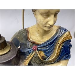 Composite table lamp modelled as a Roman Emperor donning blue robes, upon quatrefoil base modelled with rams heads and winged cherubs, H56cm excl fitting
