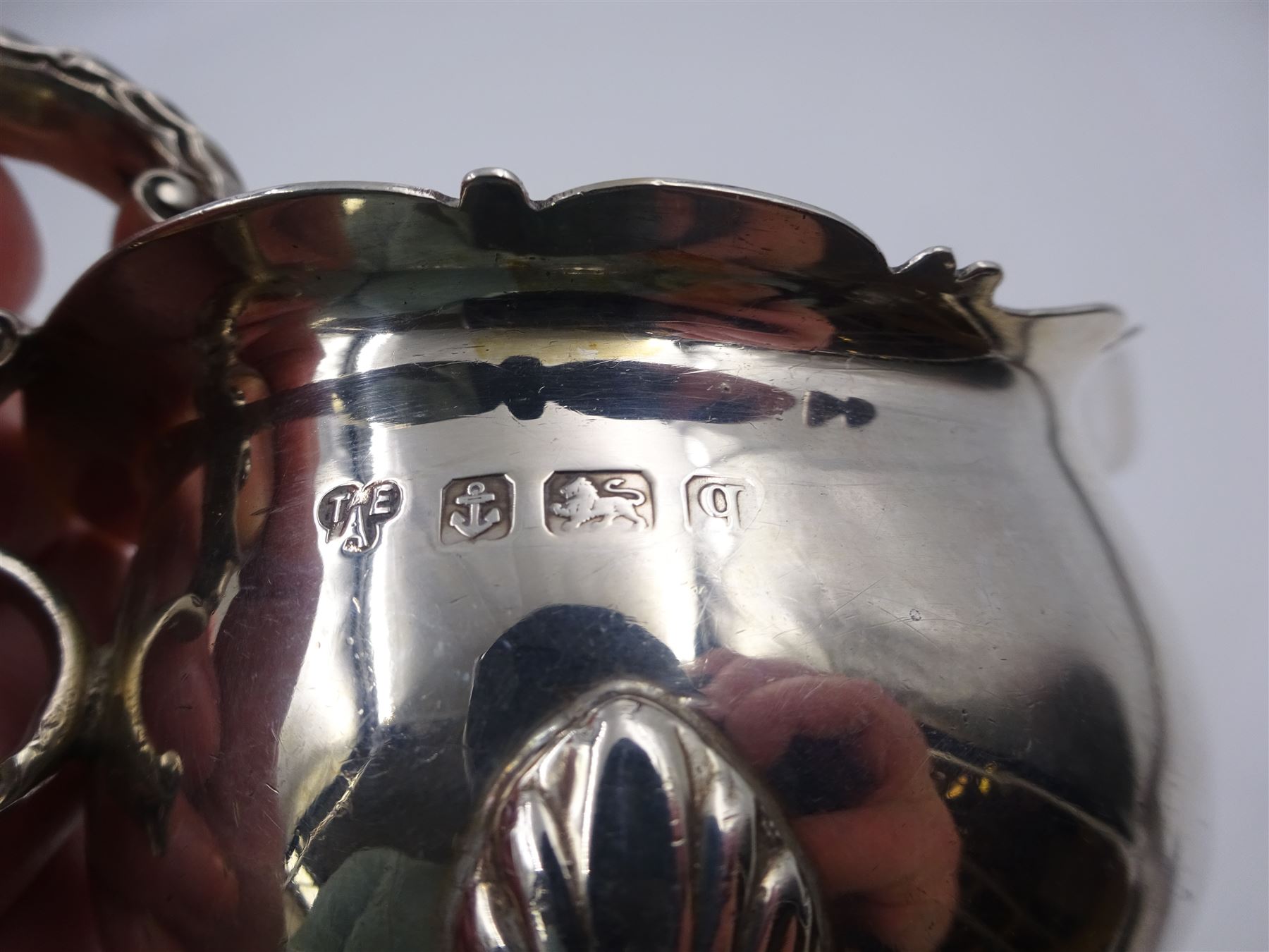 Early 20th century silver sauce boat, of typical form with shaped rim and acanthus capped flying C scroll handle, upon three palmette mounted hoof feet, hallmarked Thomas Edward Atkins, Birmingham 1915, including handle H8.5cm