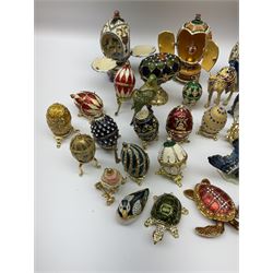 Quantity of decorative eggs to include musical examples, together with other figural decorative boxes etc