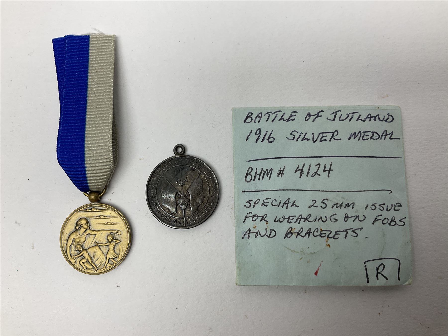 RMS Lusitania iron medallion dated 5th May, 5.5cm diameter, boxed with St Dunstan's Blinded Soldiers Profit paperwork; another unboxed similar Lusitania medallion; 30th Corps Alamein Cuxhaven medallion; Battle of Jutland 1916 silver memorial pendant; Navajo Code Talkers medallion 2000; and five other military related medallions