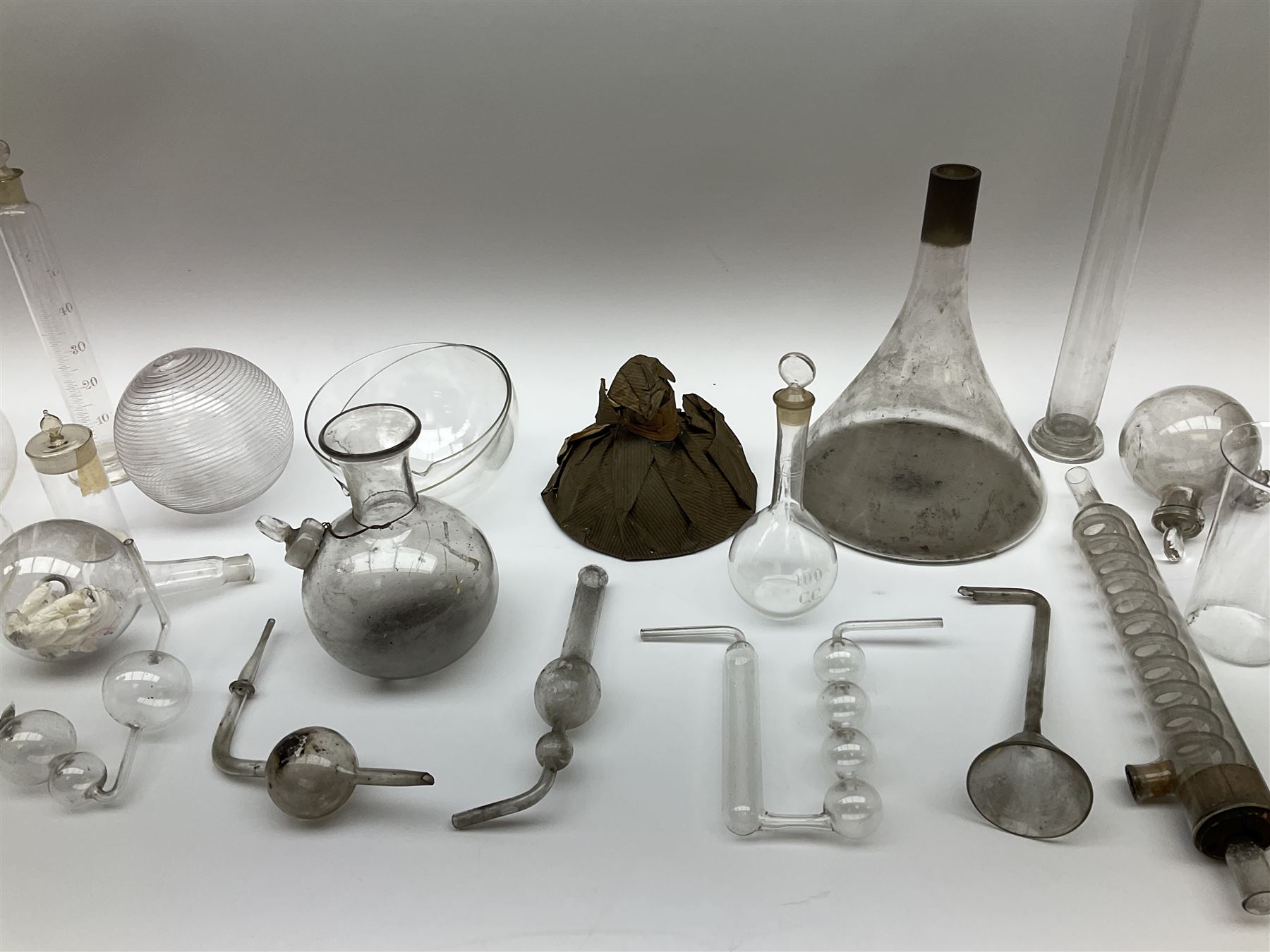Collection of 19th century and later pharmaceutical laboratory glass, to include, volumetric flasks of various sizes, conical flask, stratus flask, etc (25) Provenance: discovered in the storeroom of a long established Hull pharmacist and opticians