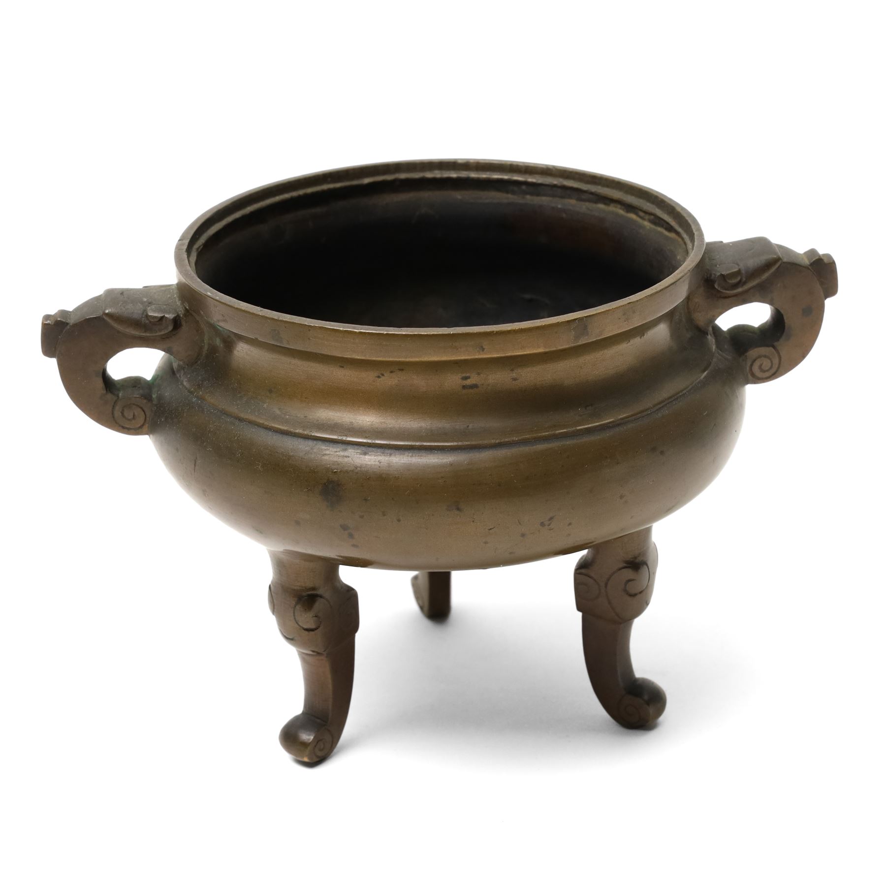 19th century Chinese bronze censer with loop handles and on shaped supports D13cm and an Asian bronze bell H17cm
