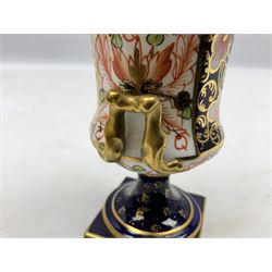 Royal Crown Derby Imari spill vase of campagna form with twin handles, with printed factory mark and pattern no 1128/1520 to base, together with Royal Crown Derby Imari miniature squat baluster vase decorated in the 1128 pattern, both with date cypher for 1891-1921, tallest H13.5cm