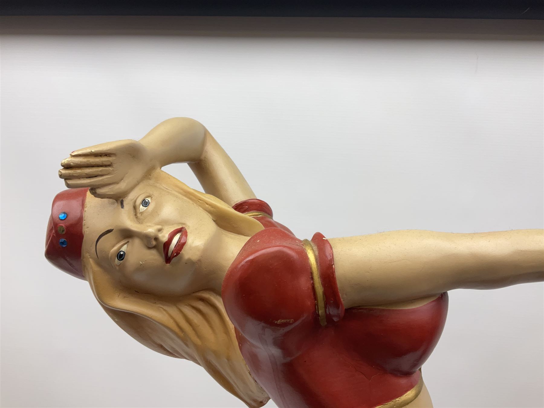 Composite Superman with cape, together with a composite female statue holding the American flag, tallest example H103cm