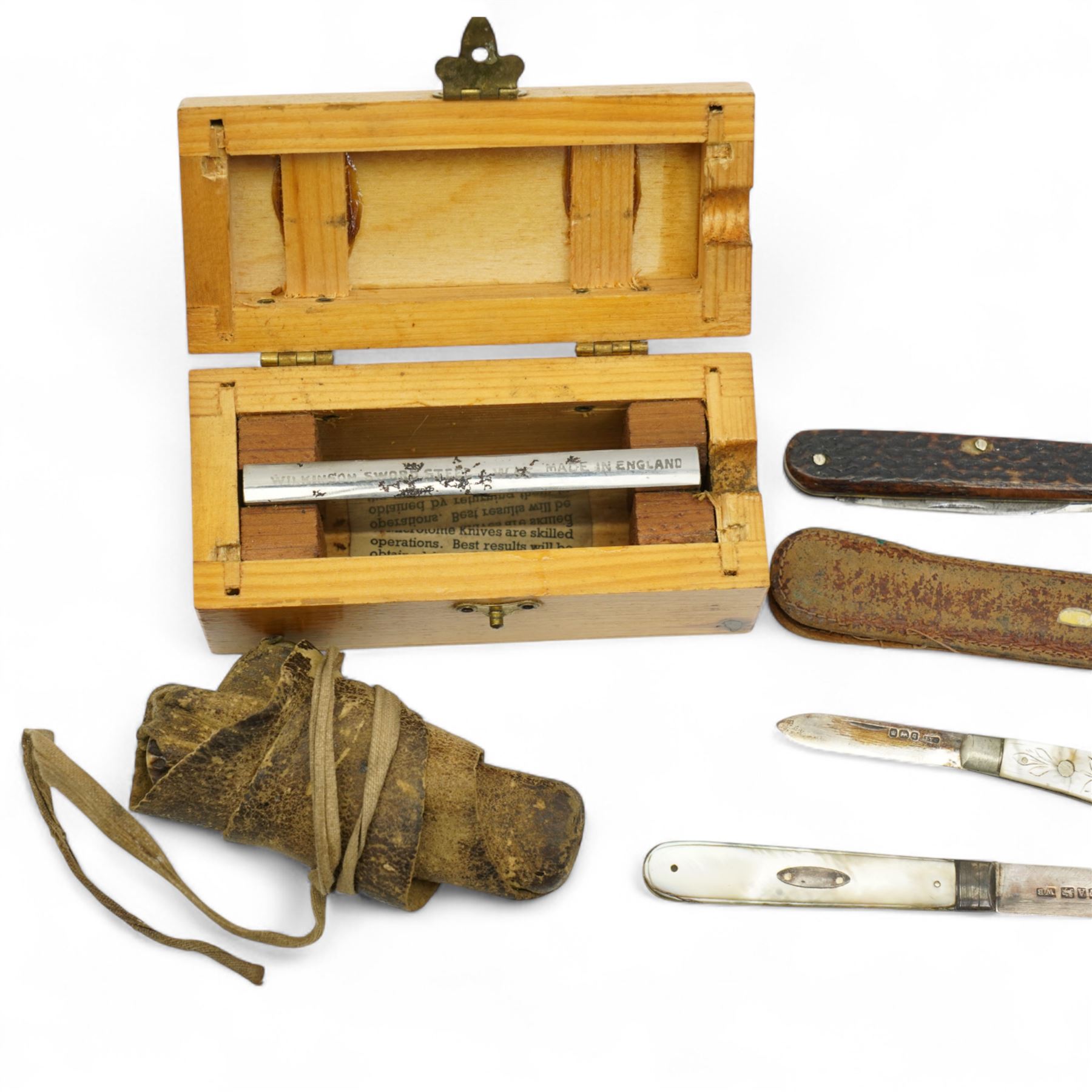 Two mother of pearl fruit knives with silver blades, 19th century pen knife with horn case by William Oates, Sheffield, another by Hunter, Sheffield, various other pen knives, cut throat razor by Barlow, Sheffield and a re-sharpening tool