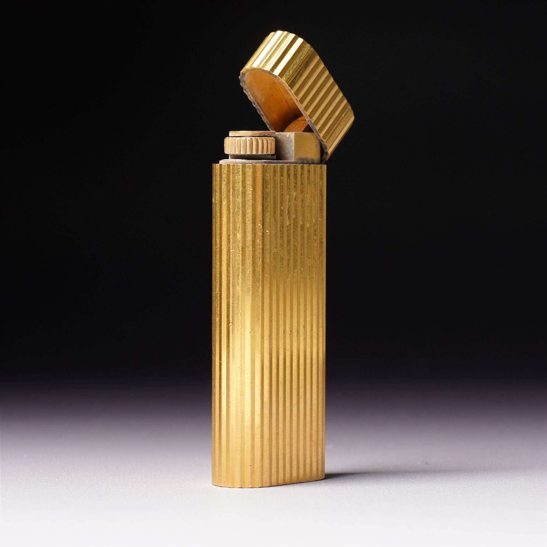 Vintage Cartier gold plated lighter with rounded edges and textured finish marked 'Cartier, Paris No16061A' and inscribed with initials in original Cartier case 