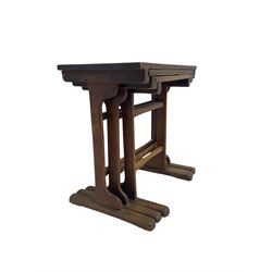 Arts & Crafts period oak nest of tables, rectangular tops on shaped upright supports, sledge feet, with visible tenon joints, 