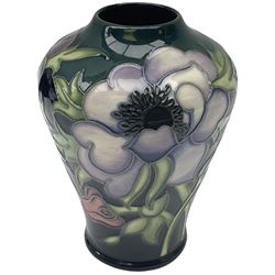 Moorcroft vase, of baluster form, decorated in the Anemone Tribute pattern designed by Emma Bossons, with impressed and painted marks beneath, H11cm, with maker's box, together with a Moorcroft bell, decorated in the Hibiscus pattern and dated 1983, with printed and painted marks to the interior, H11cm. (2). 
