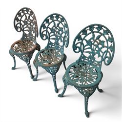 Cast iron garden table and four chairs, in the Art Nouveau style, with pierced floral and foliate decoration throughout, circular table raised on four cabriole legs with stretcher ring, chairs with shaped openwork backs and seats, in a weathered green finish
