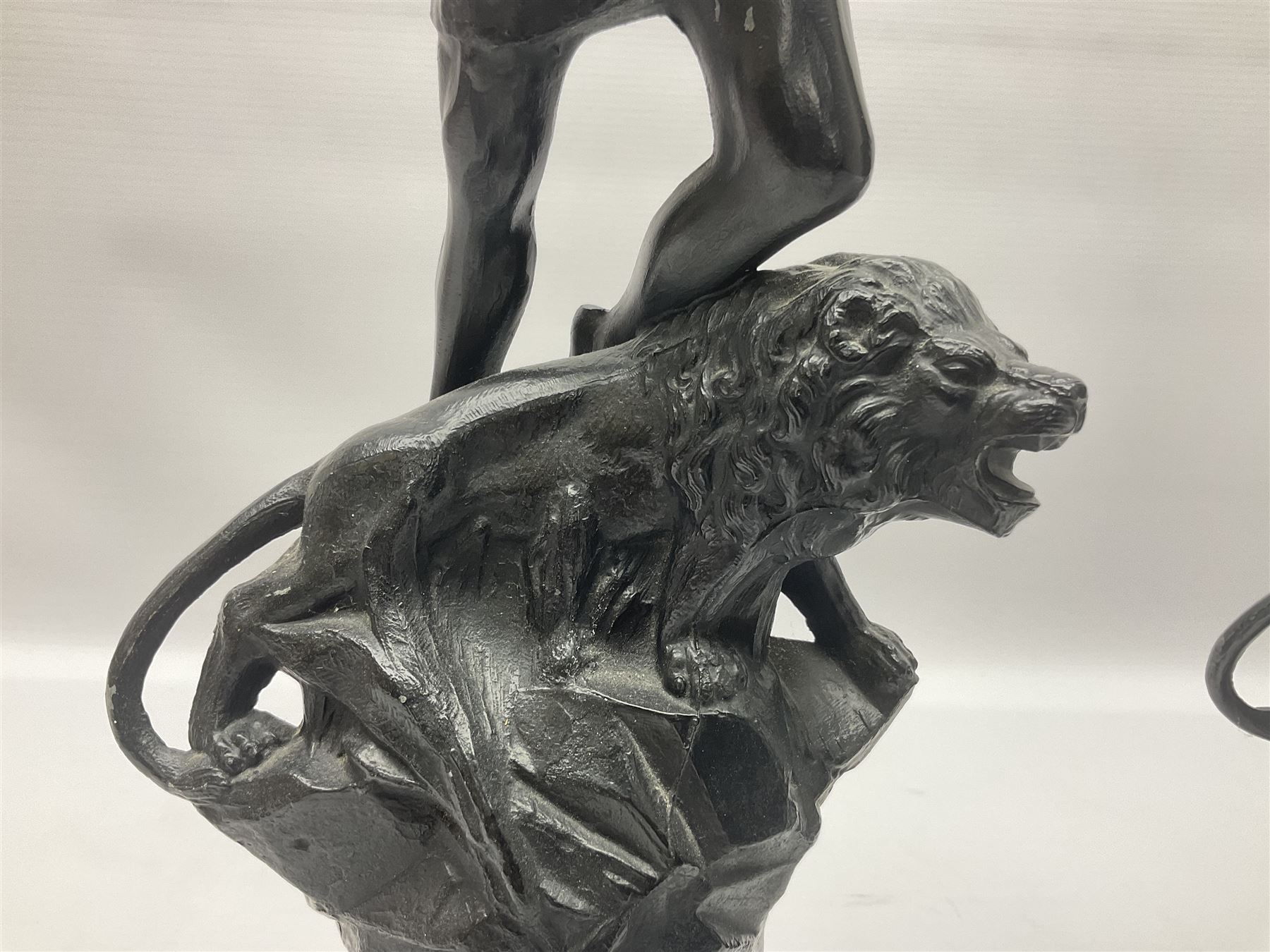 Pair of spelter figures, Le Force and Le Pouvoir, modeled as figures standing on lions, arms held aloft, H51cm 
