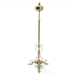 20th century brass standard lamp, urn form reservoir top with hinged cover, on a slender column with knopped detail, the stem fitted with scrolling supports, raised on a triform base with shaped cabriole supports terminating in pad feet
