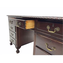Early to mid-20th century mahogany twin pedestal desk, gardroon carved top with leather inset, fitted with nine drawers