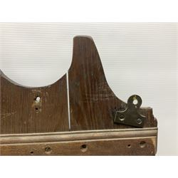 George III oak spoon rack and candle box, the rectangular backplate with shaped  pediment and two six aperture spoon racks, above a candlebox with hinged cover, with various brass spoons and a pair of brass candle snuffers, H56.5cm, W35cm, D14cm 