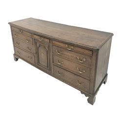 George III Lancashire oak dresser base, moulded top above nine drawers and cupboard door inlaid with fan on bracket feet W186cm, H81cam, D52cm