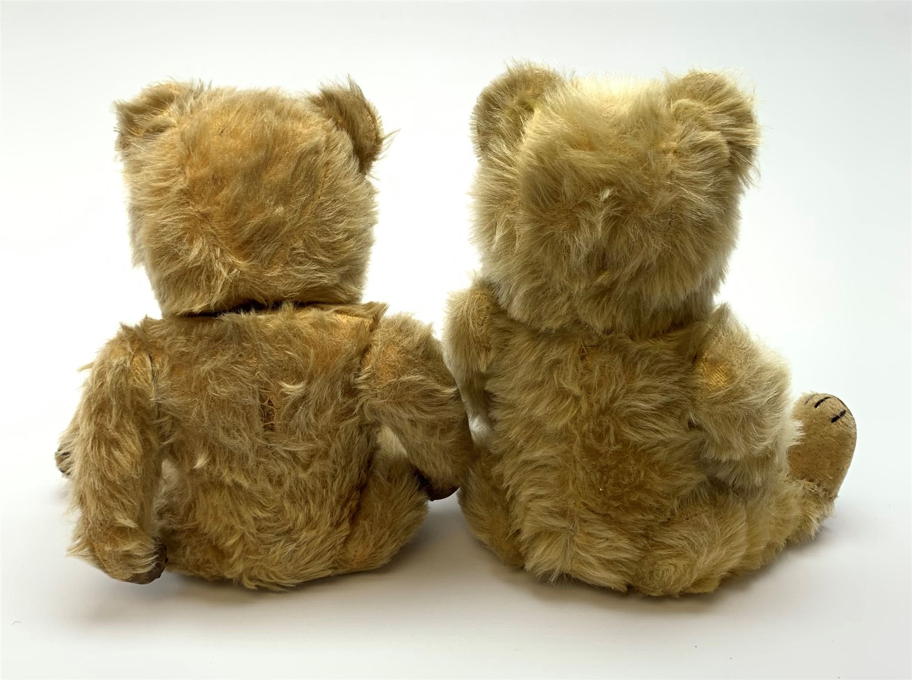 Chiltern Ting-a-Ling teddy bear c1950s with blond mohair body, swivel jointed head with glass eyes and vertically stitched nose and mouth, jointed limbs with velvet pads and card lined feet and internal chimes H14