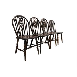 Set four mahogany wheel back dining chairs, raised on turned supports with H-stretcher