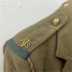 WW2 British female ATS Sergeant's service uniform grouping, consisting of four pocket female pattern service dress tunic with brass ATS shoulder titles and general service buttons; cloth lined interior with the original printed size label dated 1942; the matching khaki service dress skirt; and Greatcoat with size label dated 1945; together with army knitted sleeveless V-neck jumper; WRAC tunic, skirt and overcoat; full length cream and gold thread military evening dress by Hilliers Couture; and four webbing belts