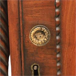  Pair of Regency mahogany bedside cabinets, rectangular top above a central cupboard door with flame mahogany veneer, flanked by spirally turned column uprights, raised on shaped supports