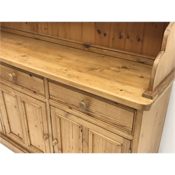  Traditional waxed pine dresser, top section fitted with two glazed display cabinets, shelf and spice drawers, lower section with three drawers and three panelled cupboards, on plinth base, W190cm, H200cm, D47cm  