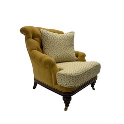 Victorian style armchair, upholstered in buttoned fabric with contrasting foliate pattern seat and scatter cushion, on turned front feet with castors