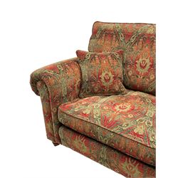 Duresta - 'Beaminster' grande two-seat sofa, traditional shape with rolled arms, upholstered in 'Althorp' russet and stone floral pattern fabric, on turned feet with brass castors
