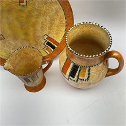 1930s Crown Ducal ceramics, designed by Charlotte Rhead, each in the 3274 Stitch pattern, comprising charger, jug and large jug, large jug H21cm 