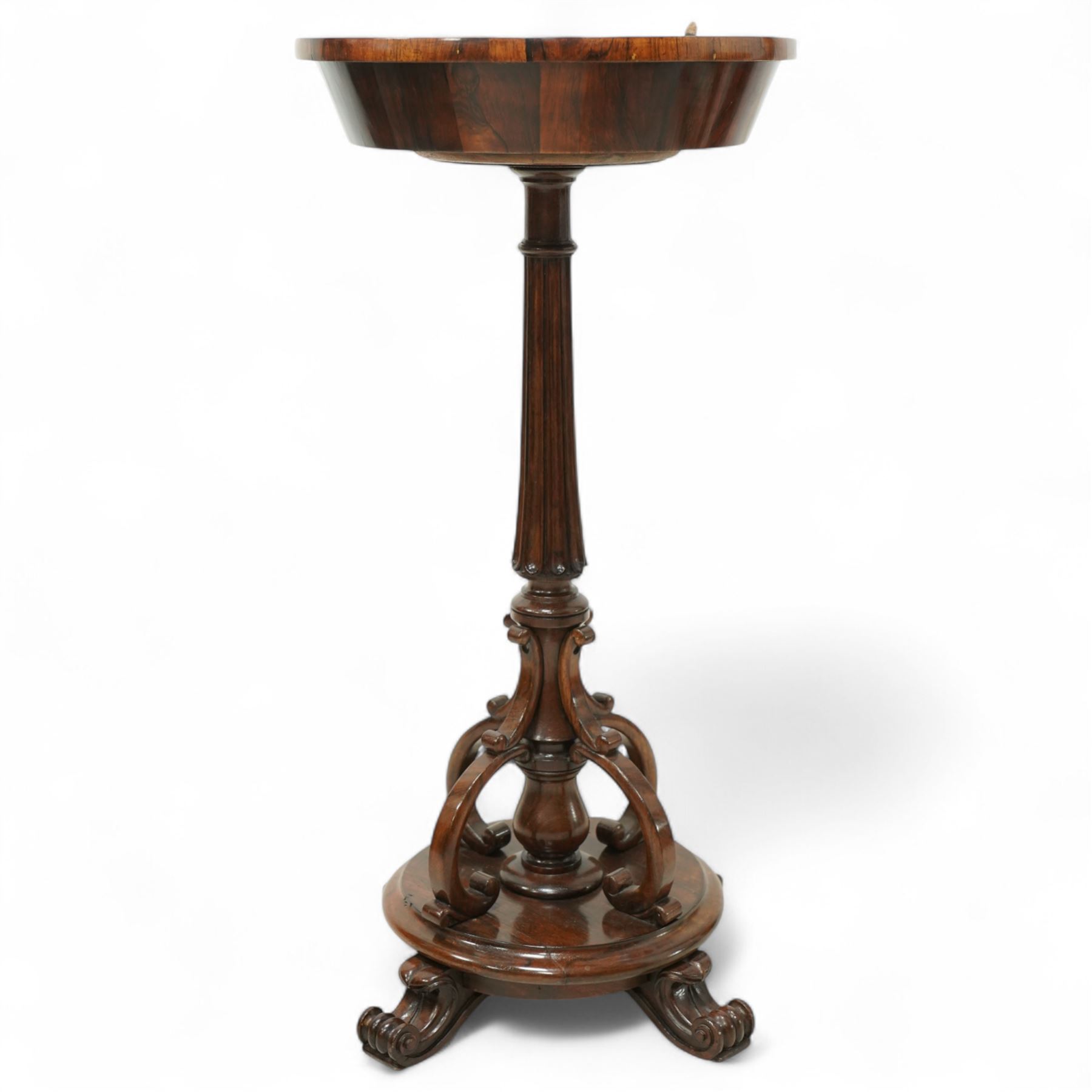 An early Victorian rosewood plant stand with removable marble top, with metal interior liner, circular top above fluted column with arched scroll supports on turned base with scroll feet 