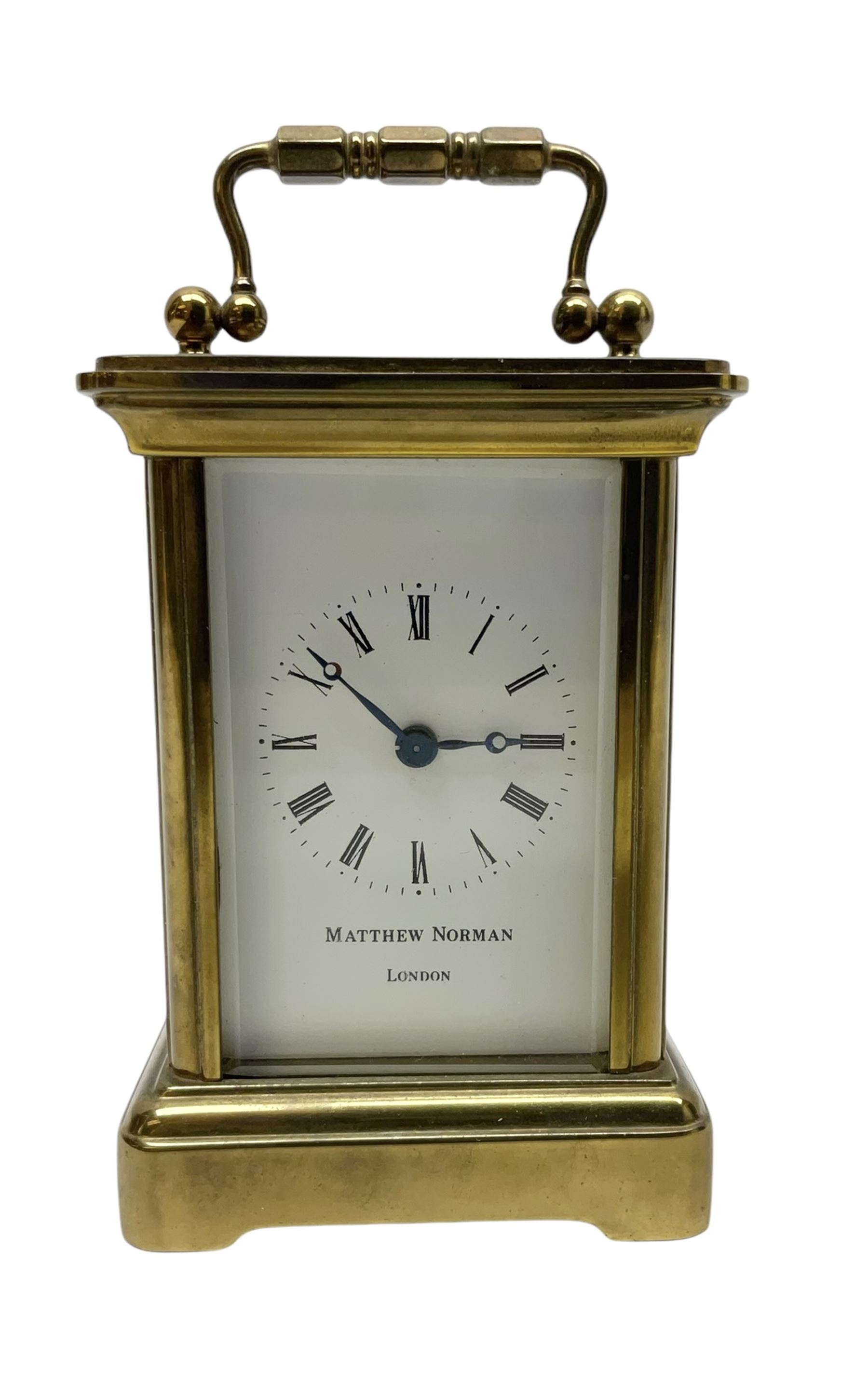Matthew Norman - miniature 20th century brass carriage clock, 8-day timepiece movement in a corniche case with an enamel dial, Roman numerals and moon steel hands, with a jewelled lever platform escapement. With key.