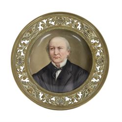 Pair of late 19th century English porcelain hand painted portrait plaques, each of circular form, set within a brass foliate and shell pierced surround, the first example depicting William Ewart Gladstone, the second Benjamin Disraeli, overall D19.5cm