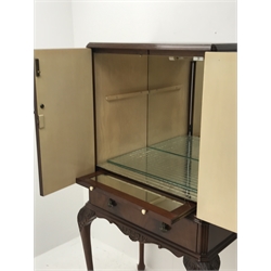 Reproduction figured mahogany cocktail cabinet, two figured doors enclosing mirrored interior with slide and shelf, fitted with single drawer, on acanthus carved cabriole supports, W75cm, H138cm, D49cm
