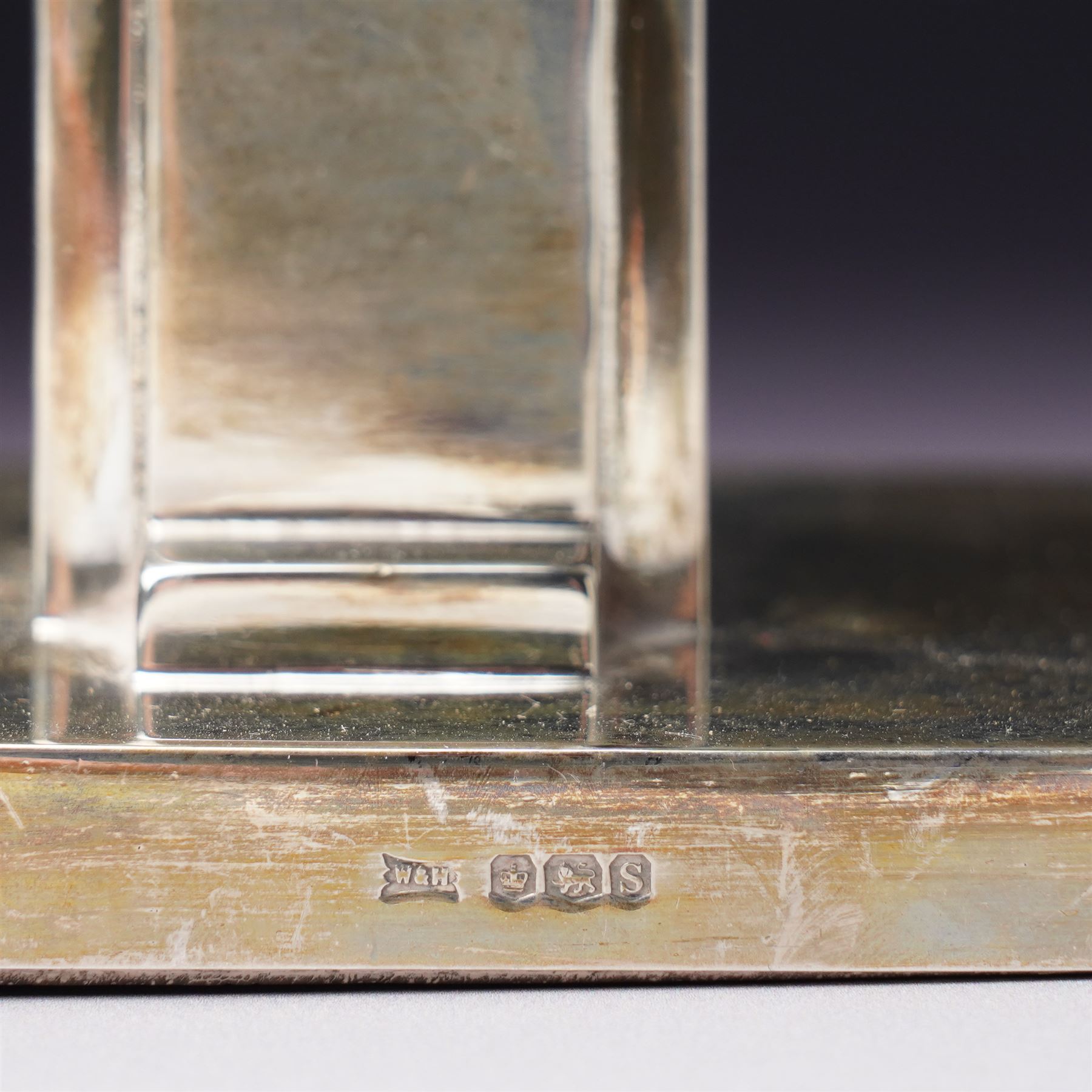 Pair of Art Deco silver candlesticks with square section stems supported by two lappets on a rectangular base H7.5cm x W9.5cm Sheffield 1935 Maker Walker & Hall