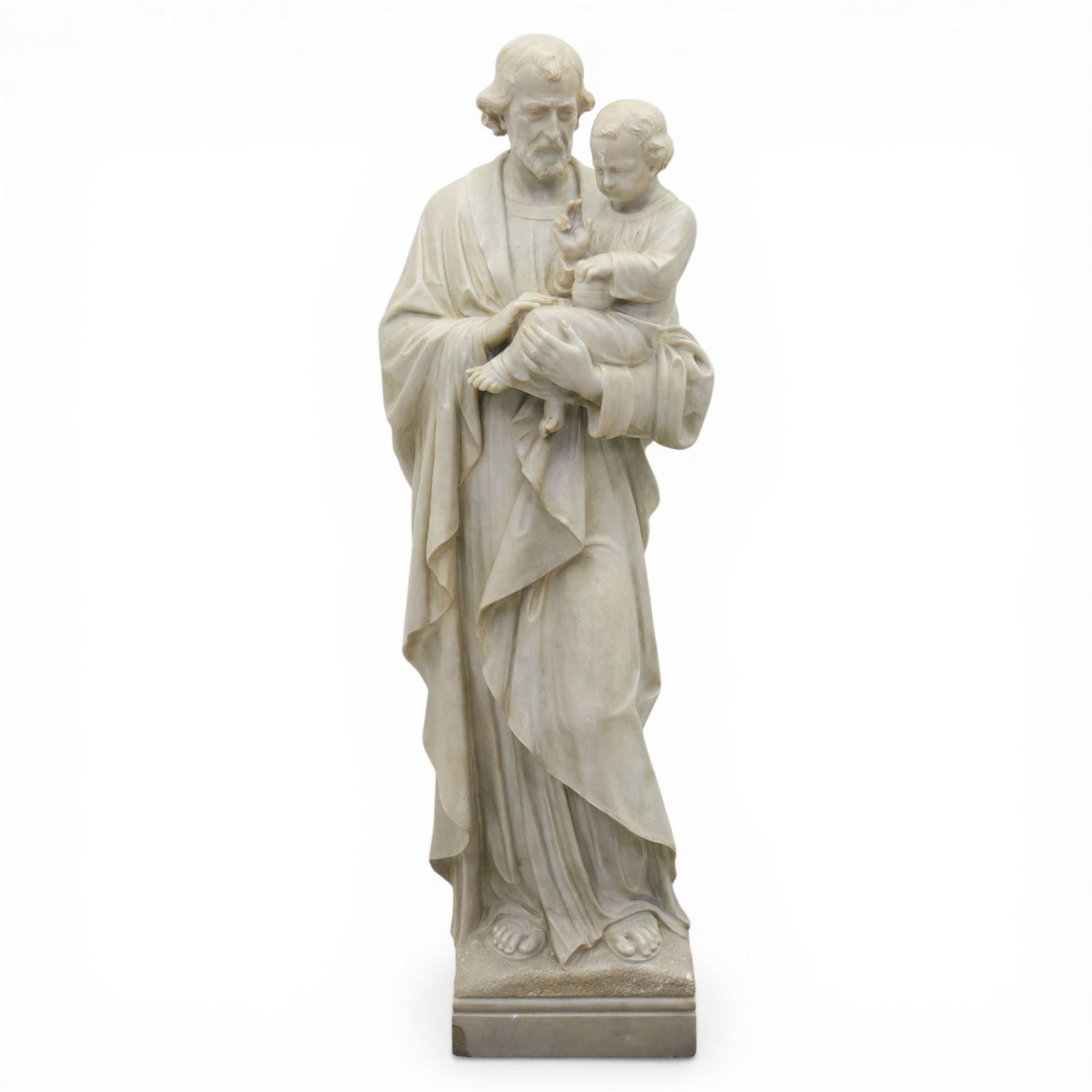 Carved stone and alabaster figure group of Saint Joseph and the Christ Child, modelled standing holding the infant, draped in flowing robes, raised on square plinth base