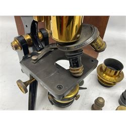 19th century brass and black japanned monocular microscope by W. Watson & Sons Ltd. 313 High Holborn, London serial no.24788 with rack and pinion focussing on tripod base H31cm; in fitted mahogany case retailed by A.H. Baird Scientific Instrument Makers Edinburgh; quantity of additional lenses and accessories; together with another similar uncased monocular microscope by W. Watson serial no.58379 (2)