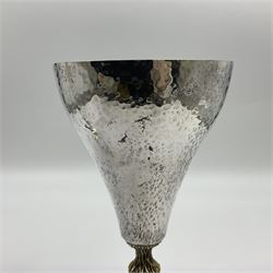 Pair of modern silver goblets by Stuart Devlin, the tapering cylindrical bowls each with spot hammered decoration and gilt interiors, the parcel gilt stems with signature textured detailing and six graduating knops, upon conforming spreading circular foot, hallmarked Stuart Devlin, London 1976, H17.7cm