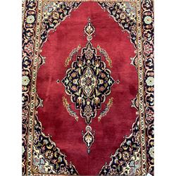Persian rug, the red ground field decorated with floral design medallion and spandrels, guarded border with repeating floral design