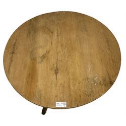 Early 19th century pine and elm tripod table; circular tilt-top over turned column and three splayed supports