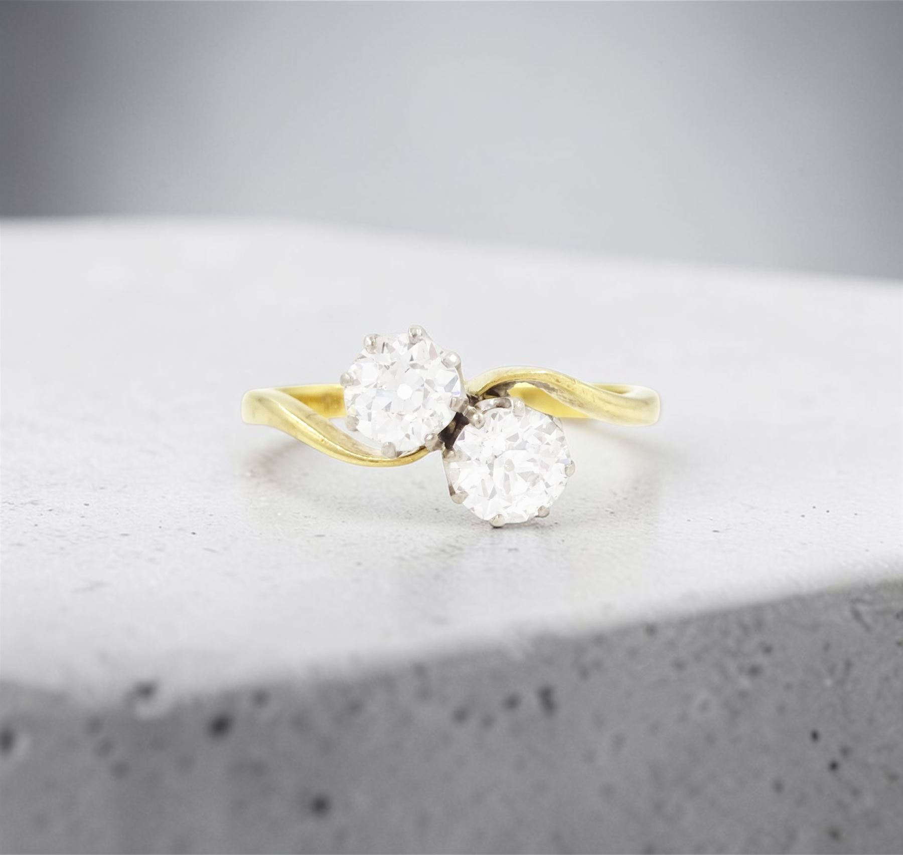 Gold diamond ring, crossover set with two old cut diamonds, stamped 18ct, total diamond weight approx 1.30 carat