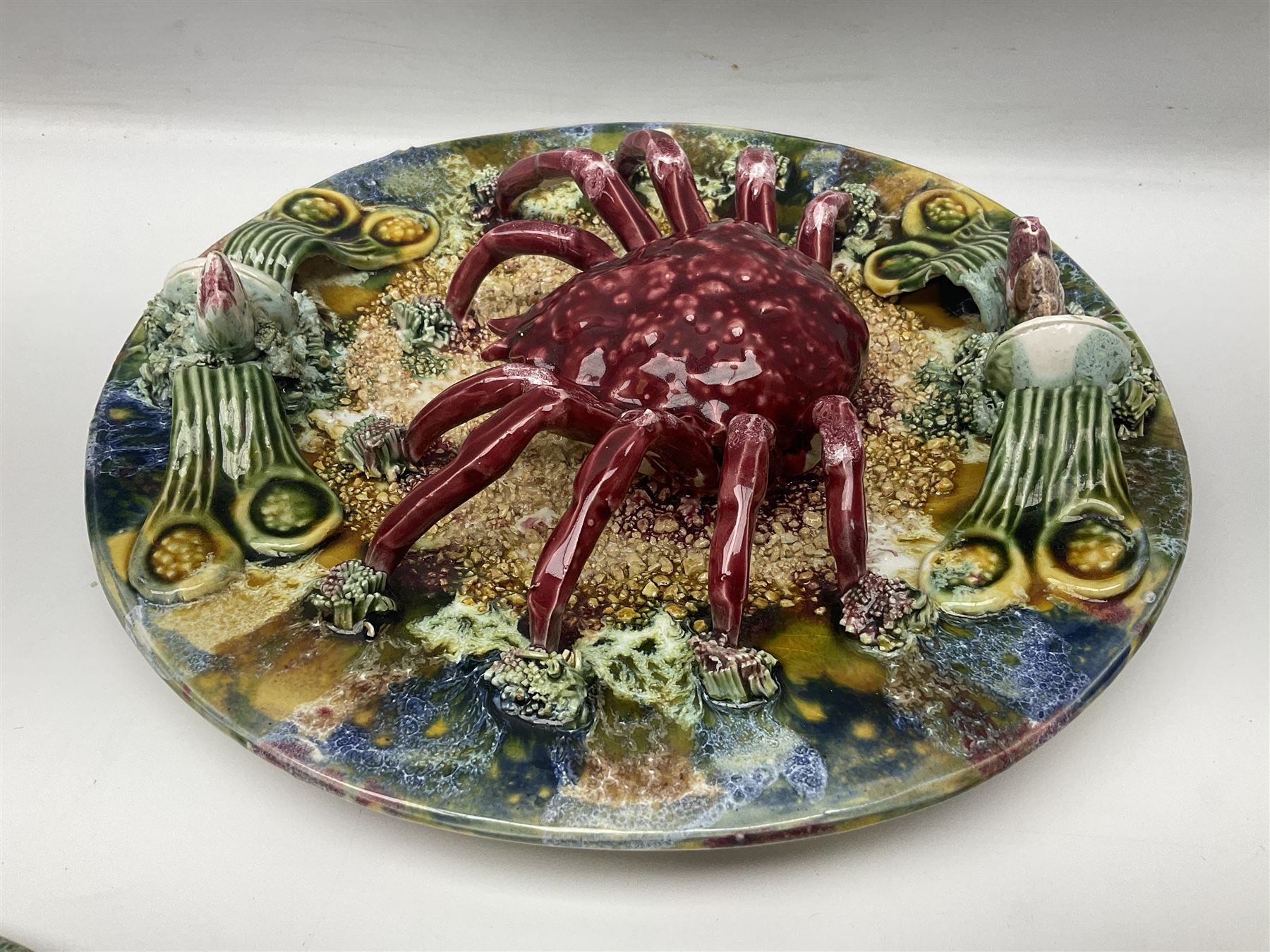 Five 20th Century Portuguese Palissy style Majolica wall plates, all depicting crustaceans to the centre modelled in relief surrounded by encrustations and shells, both with impress marks beneath, largest D29cm