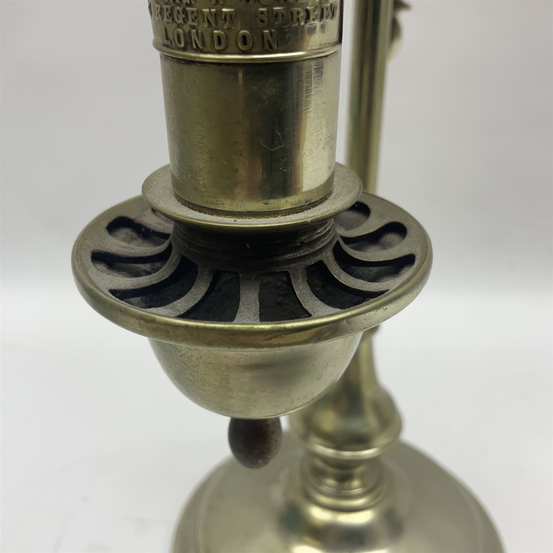 William H Honey polished brass adjustable student's oil lamp, with green glass shade, H60cm