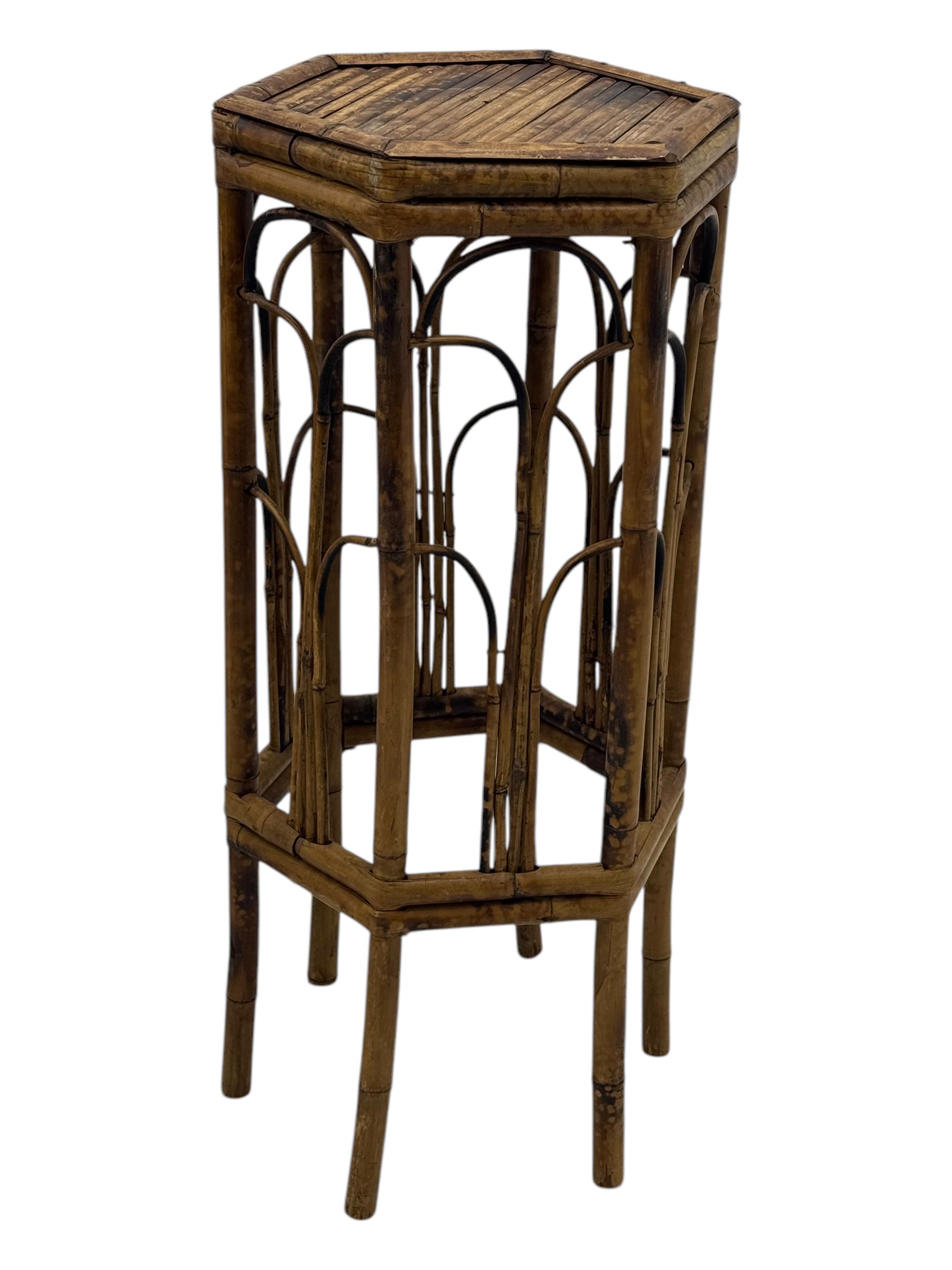 Late 19th century black-painted cane seat chair; early 20th century radial spindle-back chair with green upholstery; early 20th century mahogany single-drawer side table; mid-20th century carved wooden stool with harp motif; early 20th century hexagonal bamboo stand; two oval mirrors (7)