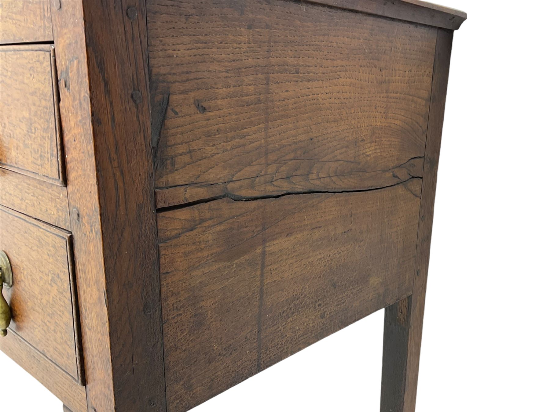 18th century Welsh oak lowboy, fitted with long drawer above three small drawers, square tapering supports, with fan carved corner brackets, circular plate and drop handles 