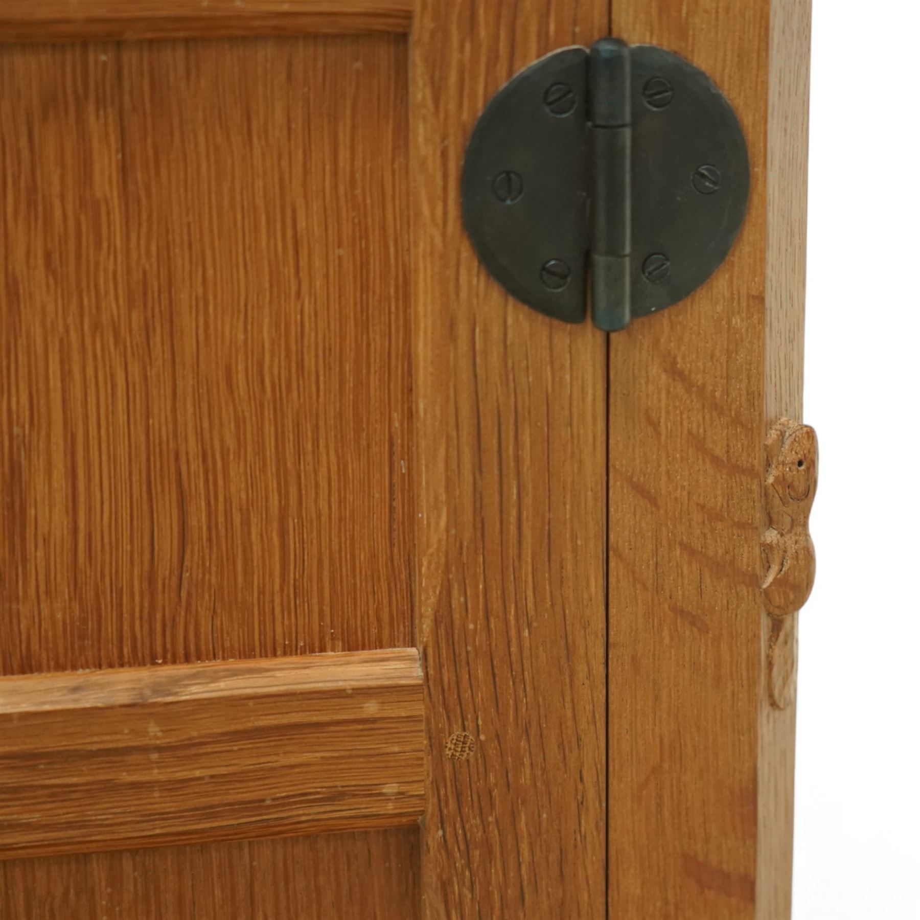 Beaverman - pair of oak bedside cabinets, each with plain rectangular top over single drawer and cupboard below with fielded panels and wrought iron hardware, with signature carved beaver, by the workshop of Colin Almack, Thirsk