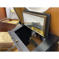 Victorian tabletop stereoscope/postcard viewer of ebonised oblong form, with carved foliate detail, together with a hand help stereoscope and a collection of slides and postcards, when open tabletop stereoscope H61cm
