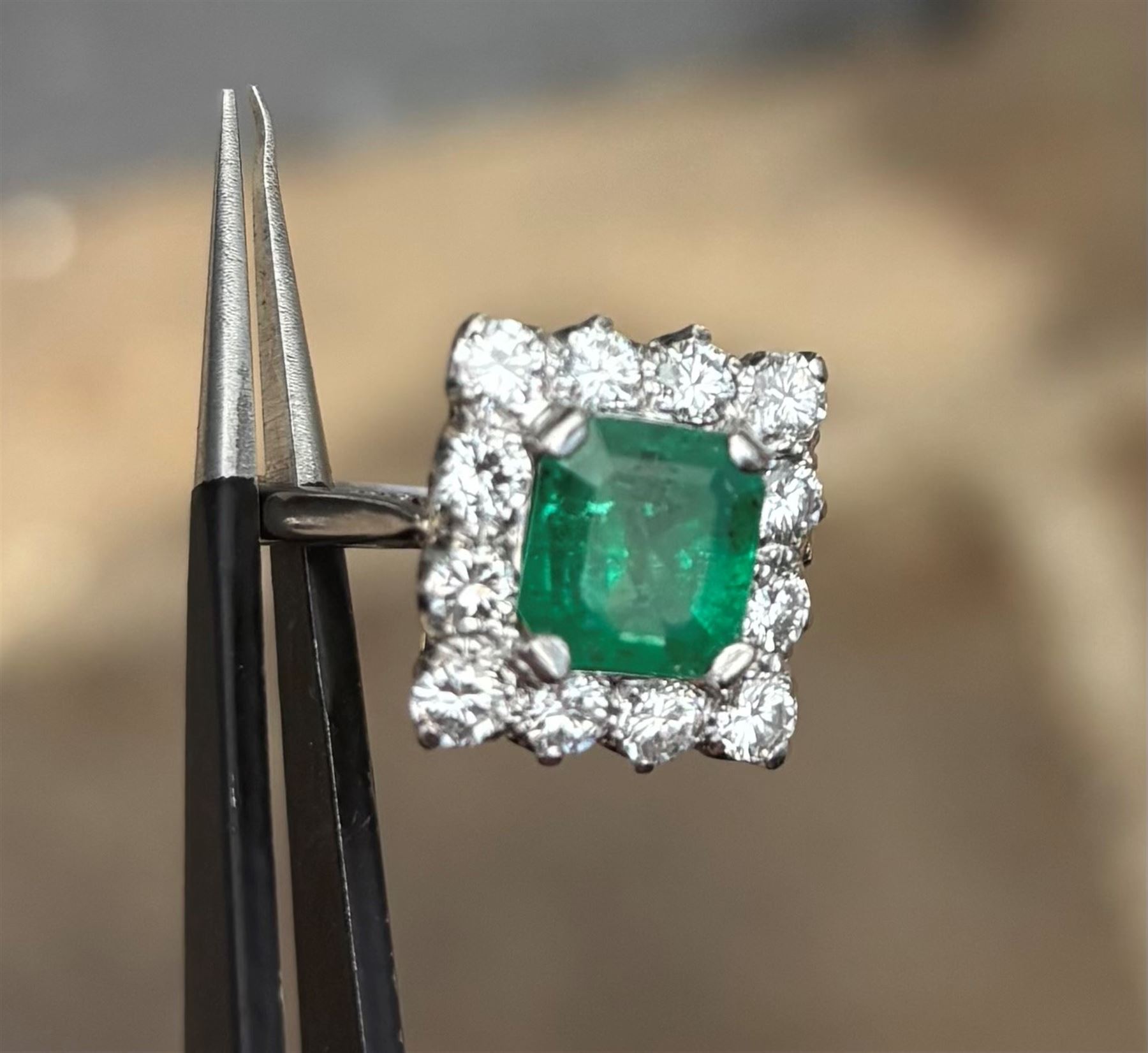 18ct white and yellow gold emerald and diamond cluster ring, single octagonal cut emerald of approx 1.55 carat, surrounded by twelve round brilliant cut diamonds, total diamond weight approx 0.95 carat